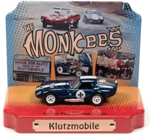Johnny Lightning Shelby Cobra Daytona Klutzmobile Blue Metallic with White Stripes The Monkees with Collectible Tin Display Silver Screen Machines Series 1/64 Diecast Model Car